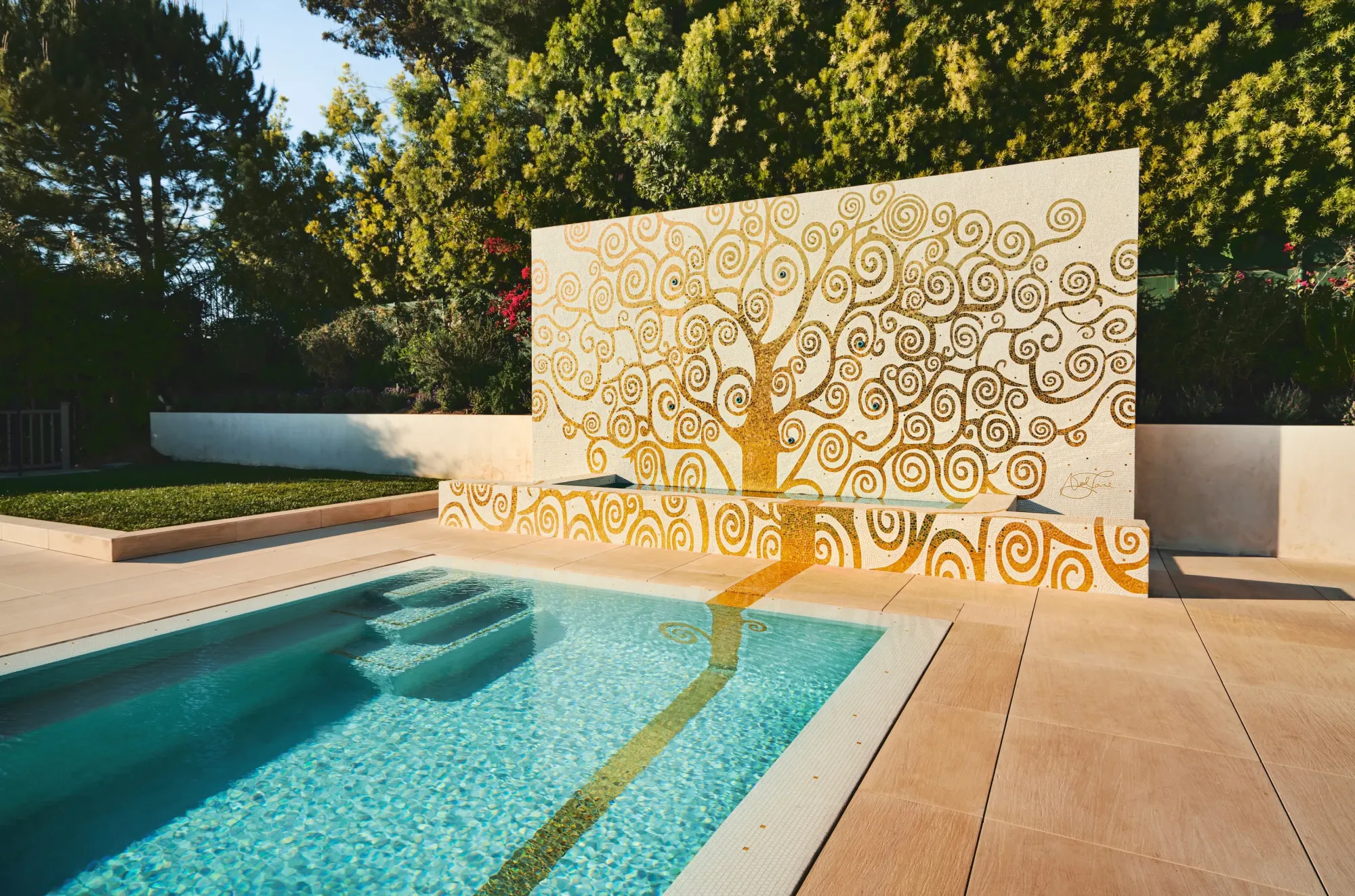 Swimming pool with a gold mosaic tree-of-life wall